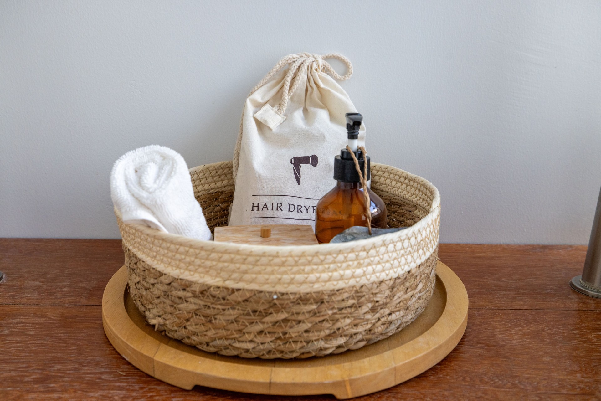 Spa Basket with Hair Dryer and Towel on Wooden Tray