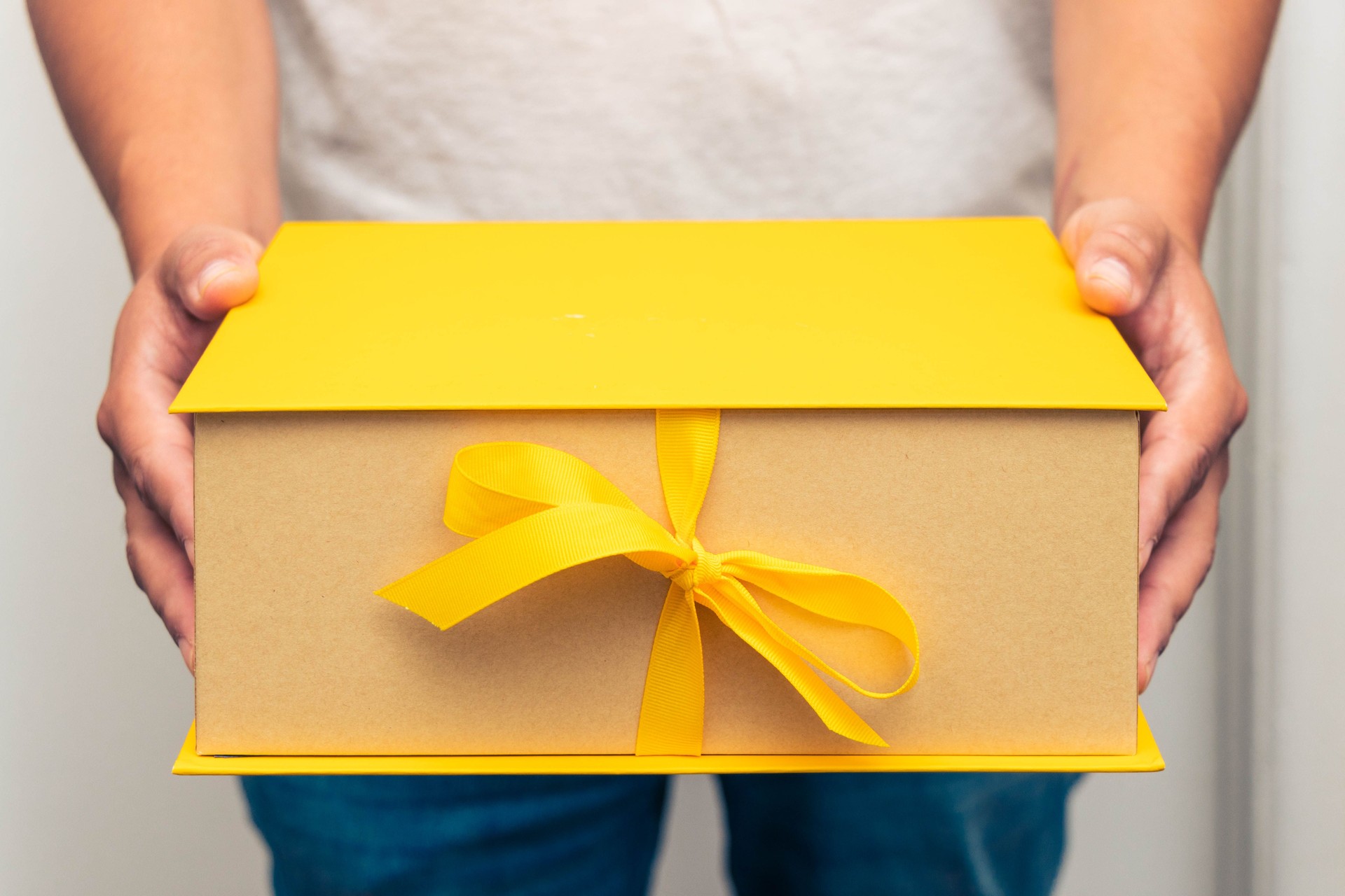 Holding A Yellow Gift Box